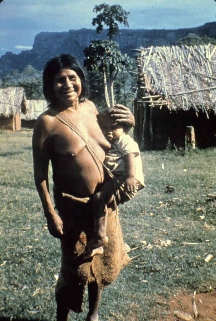Ayoré woman baby sitting, carrying the infant in it's woven baby sling